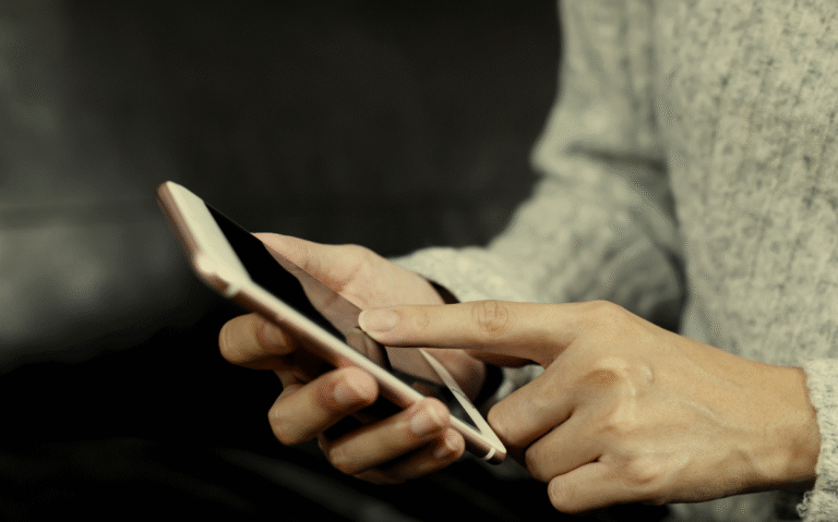 Hands holding a mobile device, suggesting the use of smartphones for various personal or professional purposes.